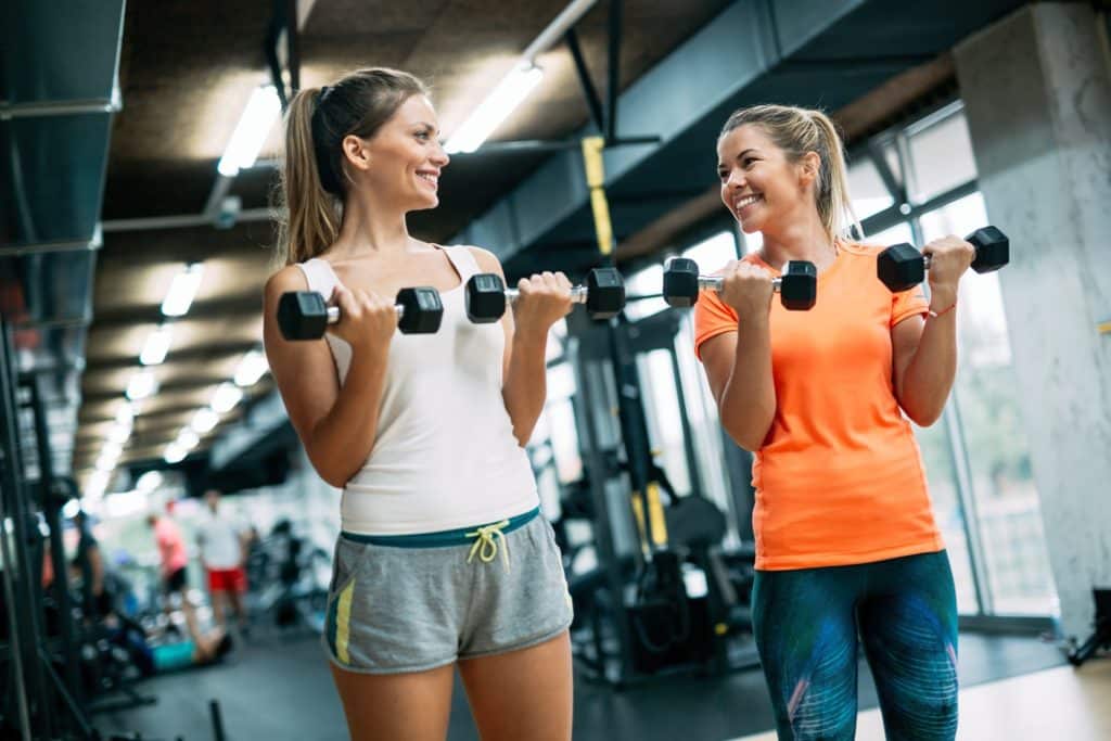 Beautiful women working out in gym together